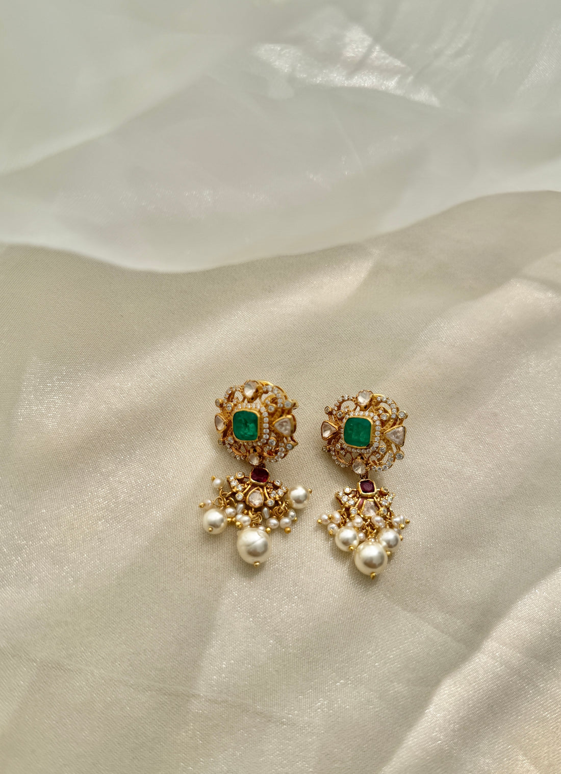 Sonia Earrings featuring green rectangular centres, red accents, clear-stone detailing and dangling white beads