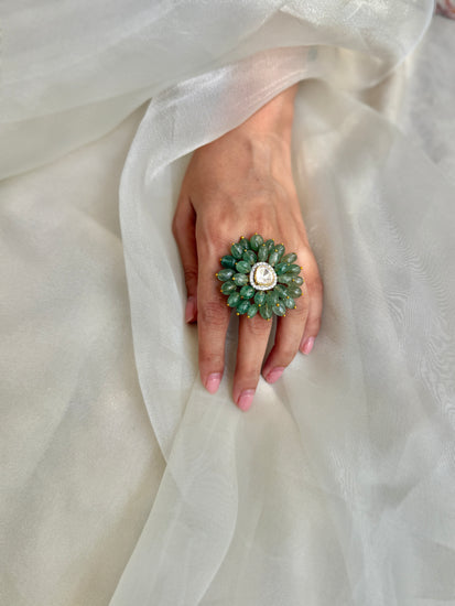 Trisha Ring featuring green oval beads arranged in a floral design around a clear triangular centre.