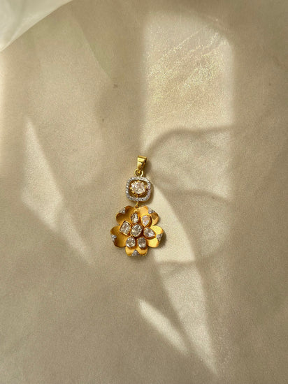Kusum Polki Pendant featuring sculpted gold-tone flower petals and clustered clear stones beneath a stone-set bail.