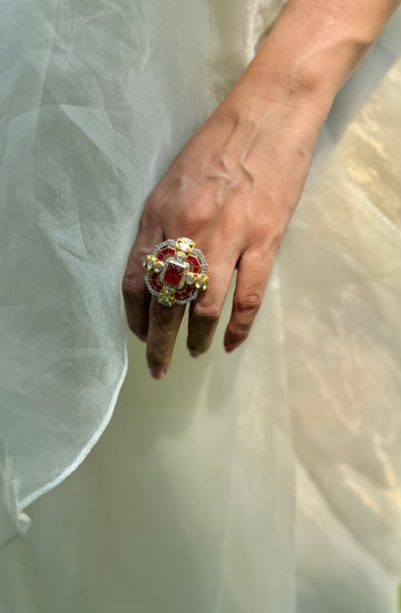 Durbar Ring featuring a rectangular red centre with geometric pink accents and clear-stone detailing in a gold-tone setting.