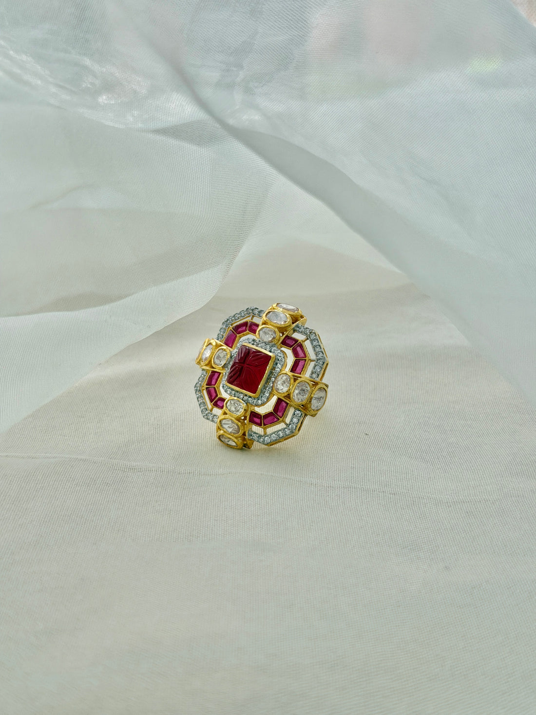 Durbar Ring featuring a rectangular red centre with geometric pink accents and clear-stone detailing in a gold-tone setting.