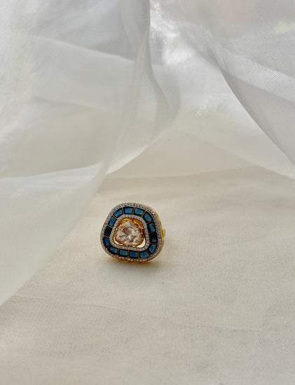 Rukaya Ring featuring a clear triangular centre surrounded by dark blue accents and clear-stone detailing