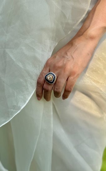 Rukaya Ring featuring a clear triangular centre surrounded by dark blue accents and clear-stone detailing