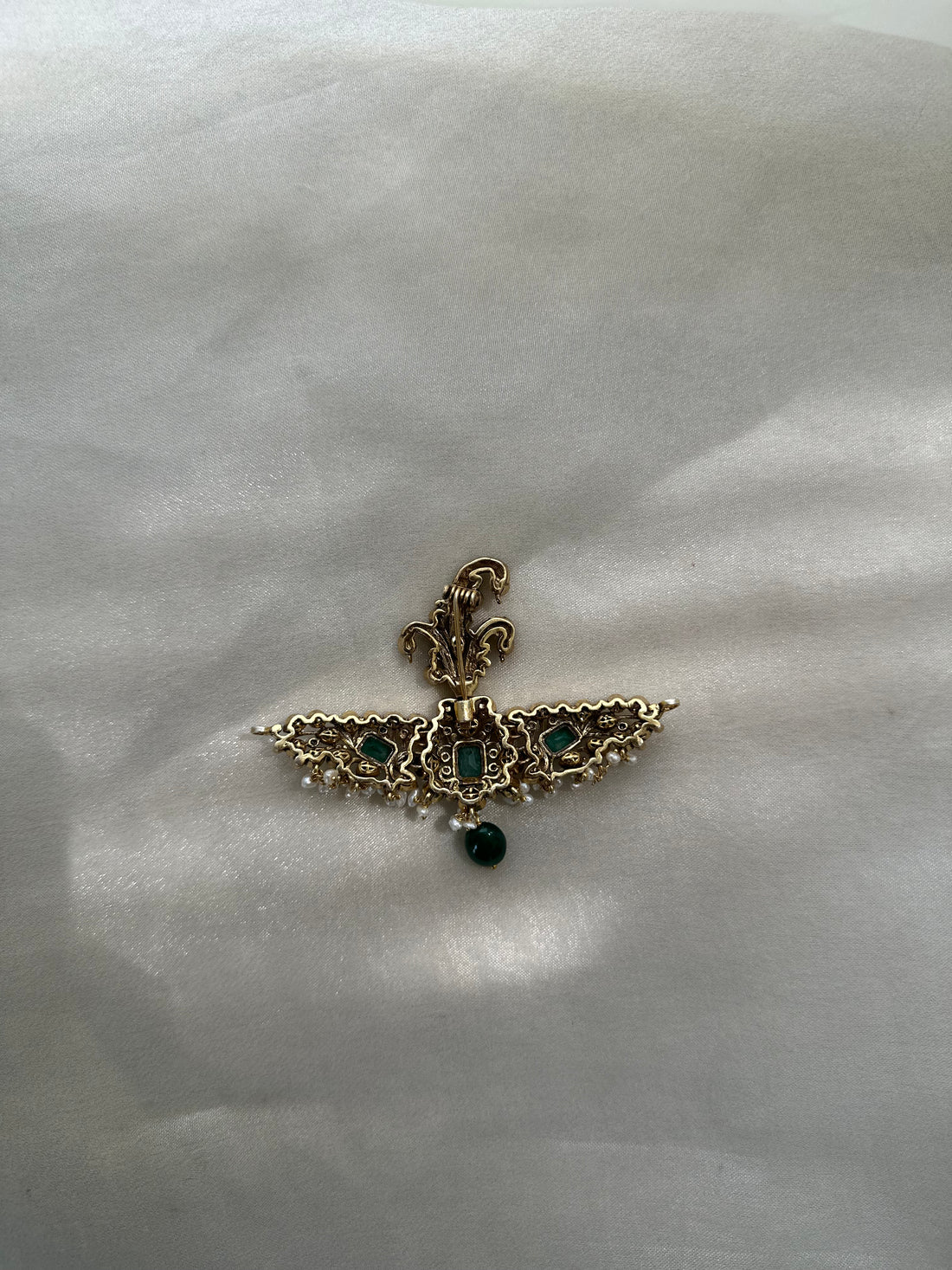 Huzoor Sarpech featuring a curved green plume, clear-stone detailing, white bead fringe and a dangling green bead.