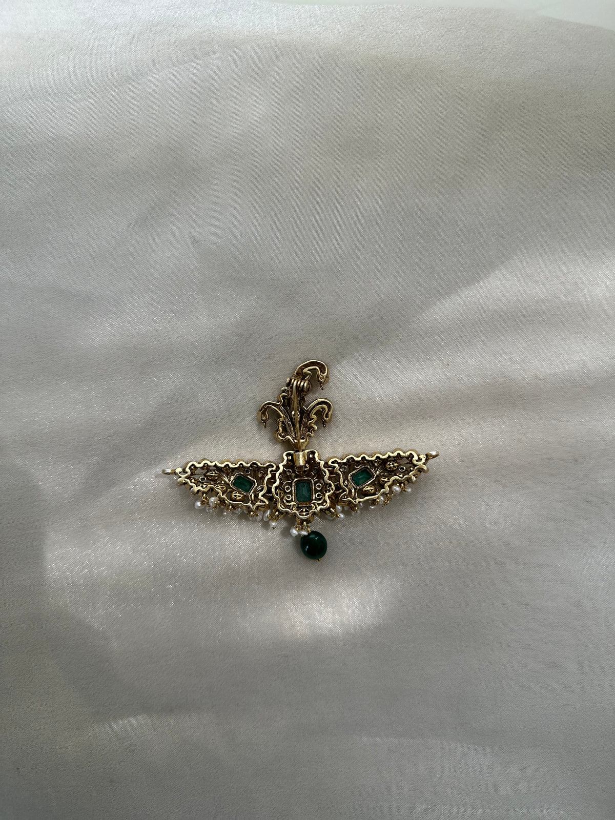 Huzoor Sarpech featuring a curved green plume, clear-stone detailing, white bead fringe and a dangling green bead.