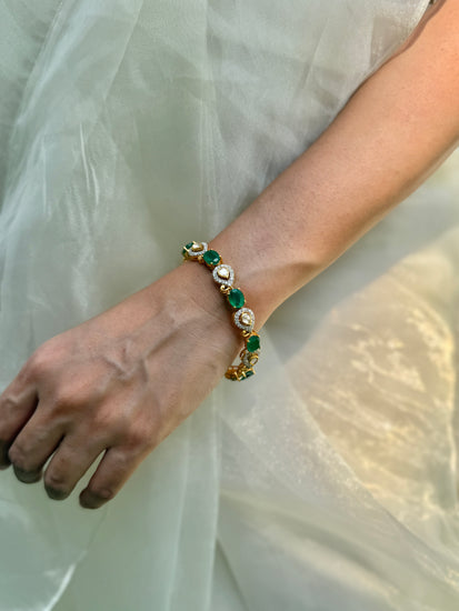 Arzaana Bracelet featuring alternating green oval stones and clear teardrop links in gold-tone settings