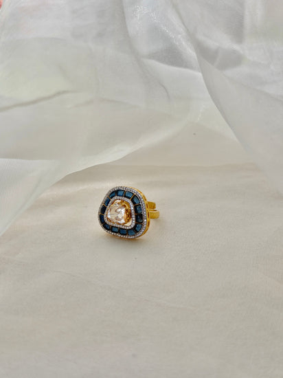 Rukaya Ring featuring a clear triangular centre surrounded by dark blue accents and clear-stone detailing