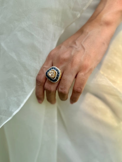 Rukaya Ring featuring a clear triangular centre surrounded by dark blue accents and clear-stone detailing