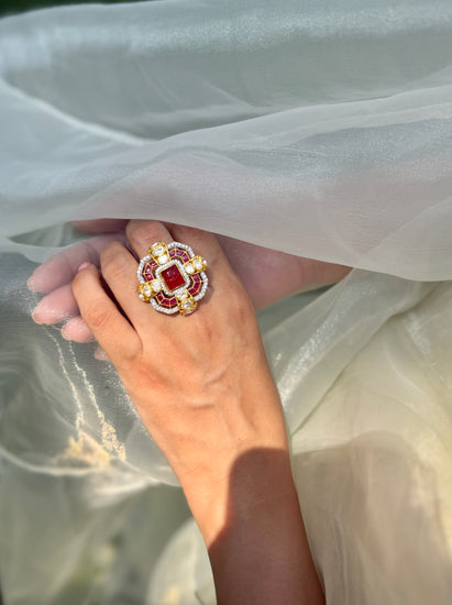 Durbar Ring featuring a rectangular red centre with geometric pink accents and clear-stone detailing in a gold-tone setting.