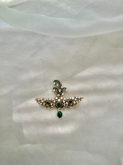 Huzoor Sarpech featuring a curved green plume, clear-stone detailing, white bead fringe and a dangling green bead.