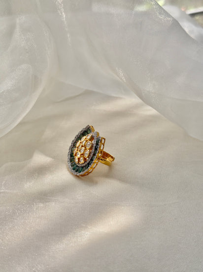Dua Ring featuring a clear-stone cluster surrounded by a curved dark green border in a gold-tone setting.